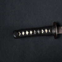 Close-up of the kodachi tsuka showing the sode and naginata themed menuki.